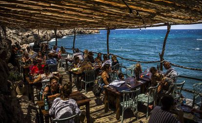 Diners at a beach bar in Cala Deià.