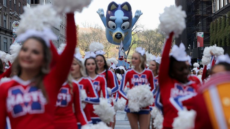 Bluey balloon flies as Spirit of America cheerleaders participate in the 96th Macy's Thanksgiving Day Parade in Manhattan, New York City 