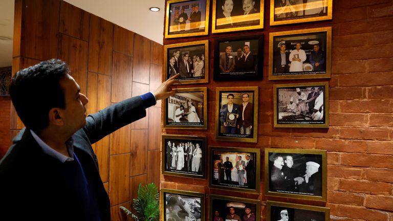 Moti Mahal's managing director Monish Gujral next to photographs of celebrities and politicians Pic: Reuters