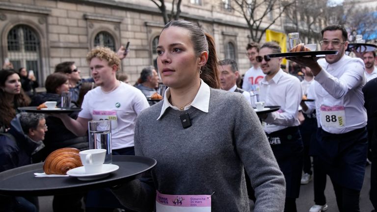 Pic: AP Waiters carry trays with a cup of coffee, a croissant and a glass of water as they take part in a waiter's run through the streets of Paris, Sunday, March 24, 2024. (AP Photo/Christophe Ena)