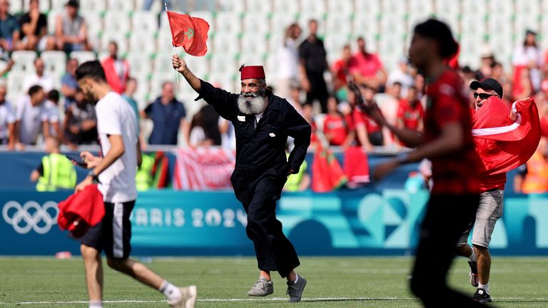 Fans invaded the pitch at the end of the match. Pic: Reuters