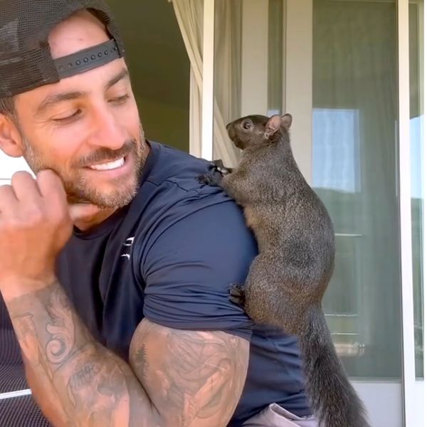 Mark Longo with his pet squirrel Peanut. Pic: AP